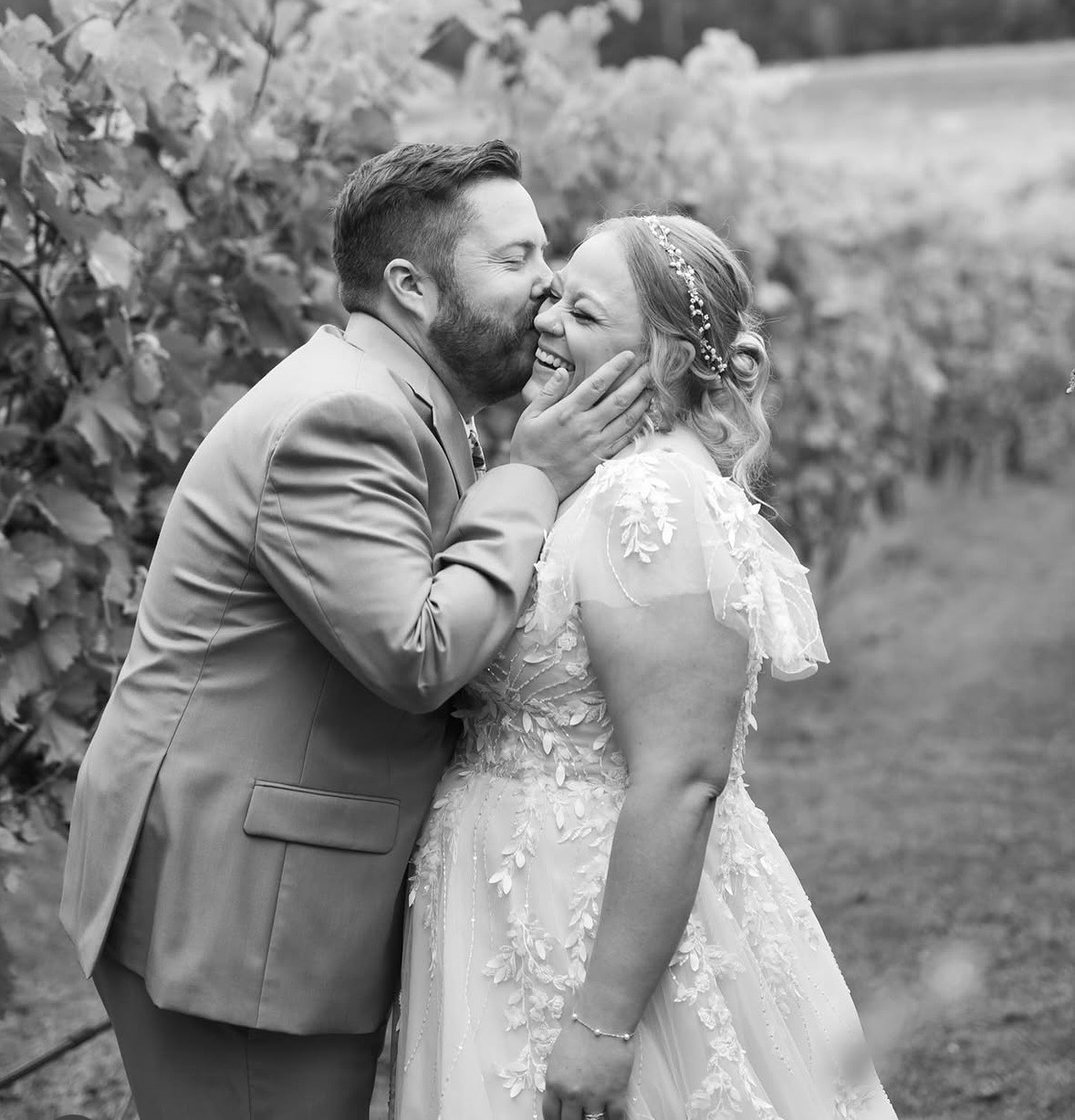 Bride and groom vineyard kiss